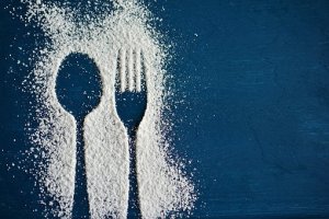 outline of spoon and fork with sugar